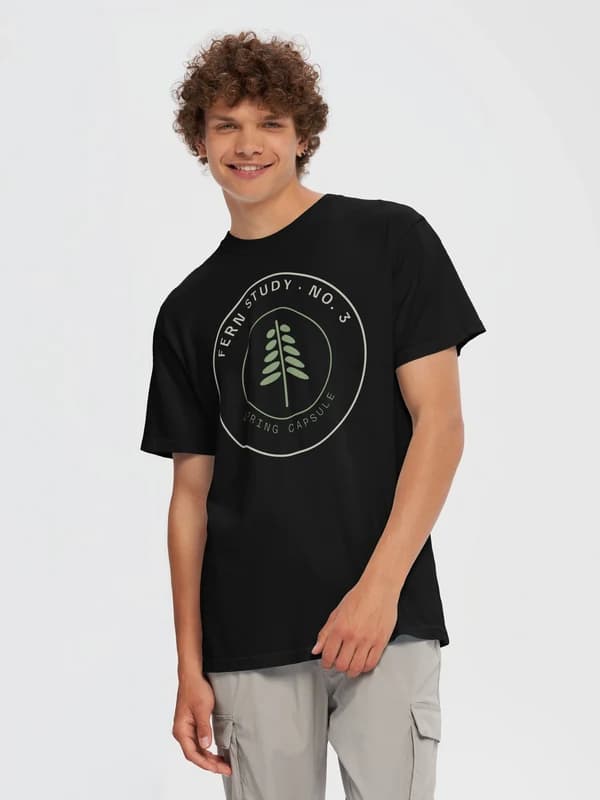 The Fern Study No. 3 design on a black heavyweight tee, worn by a model, as Fourthwall renders it